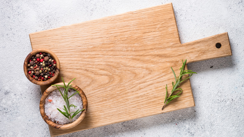 Salt and pepper on wood cutting board