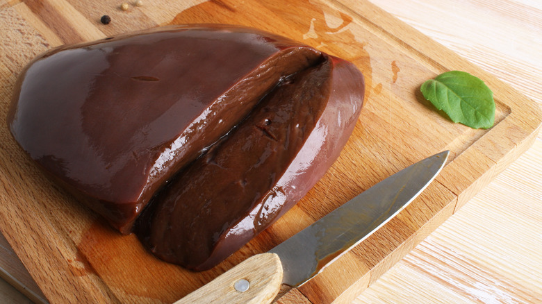 Sliced beef liver on cutting board.