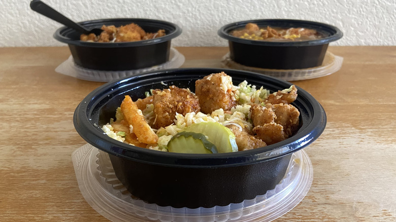 Two bowls behind Nashville Hot Loaded Fries Bowl