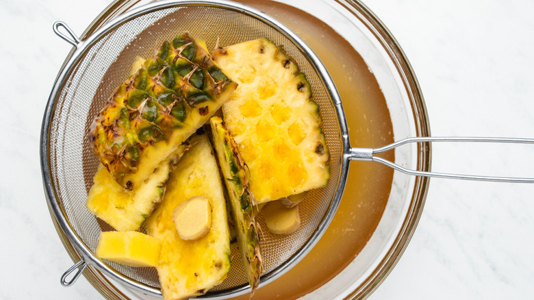 pineapple skins strained over bowl