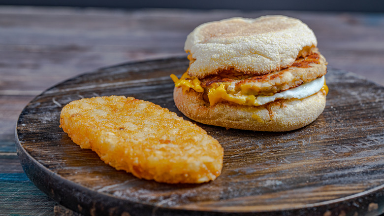 mcmuffin and hashbrown on wooden surface