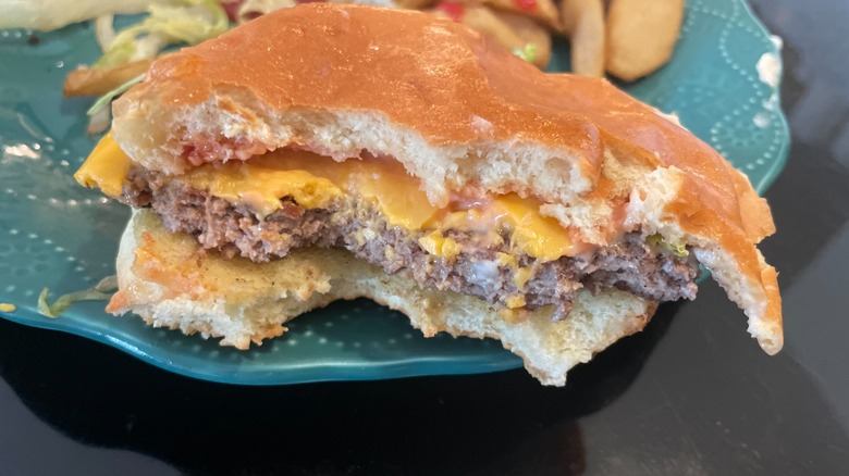 half eaten burger on plate