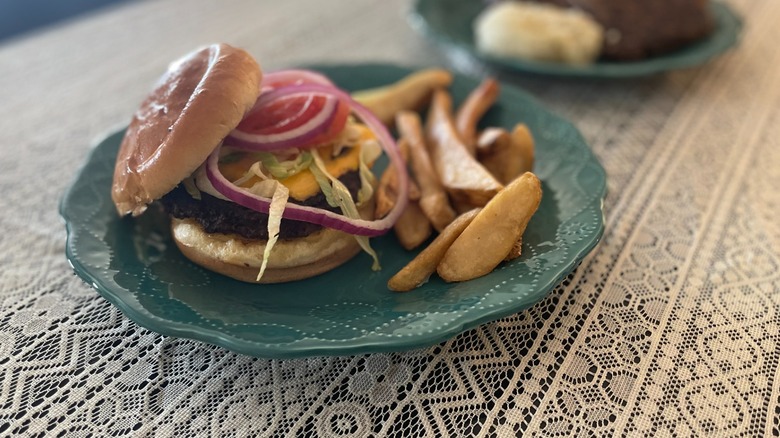 cheeseburger with toppings on plate