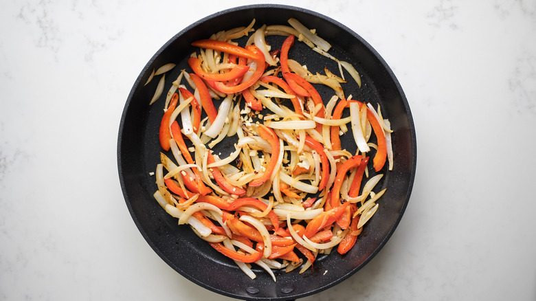 sauteed peppers and onions in skillet