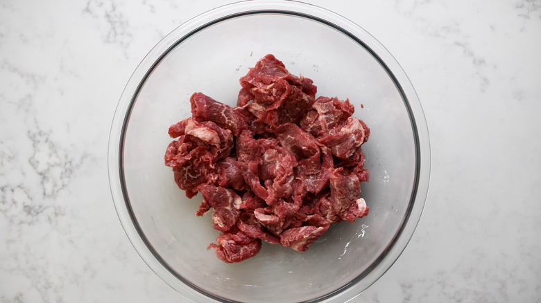 raw flank steak in bowl