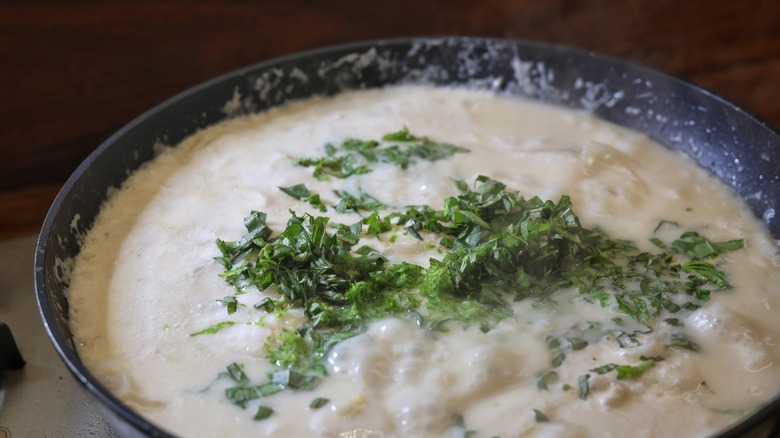 lime zest and basil in coconut broth