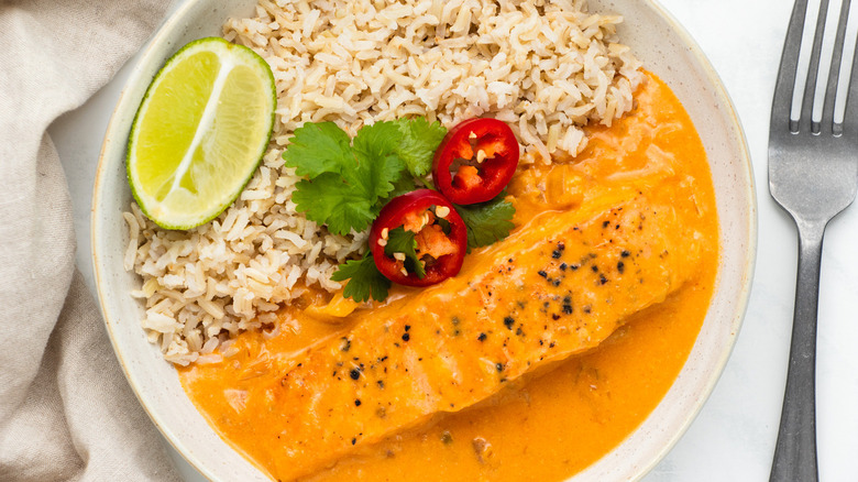 salmon curry with rice and garnishes