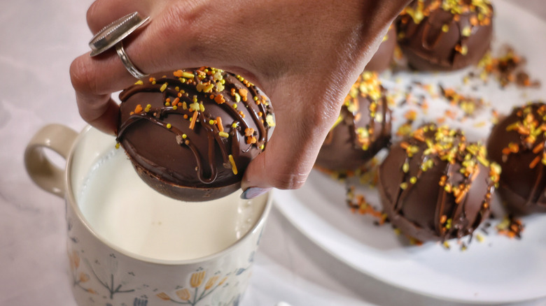 dropping hot chocolate bomb into mug