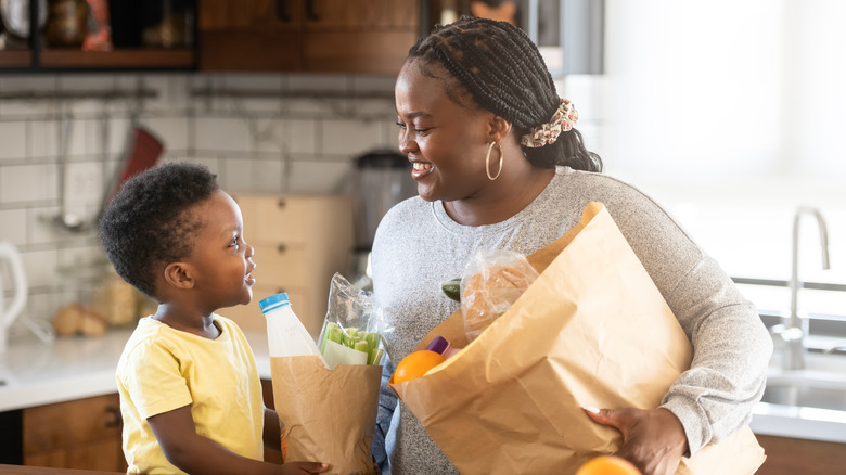 mom and son with groceries