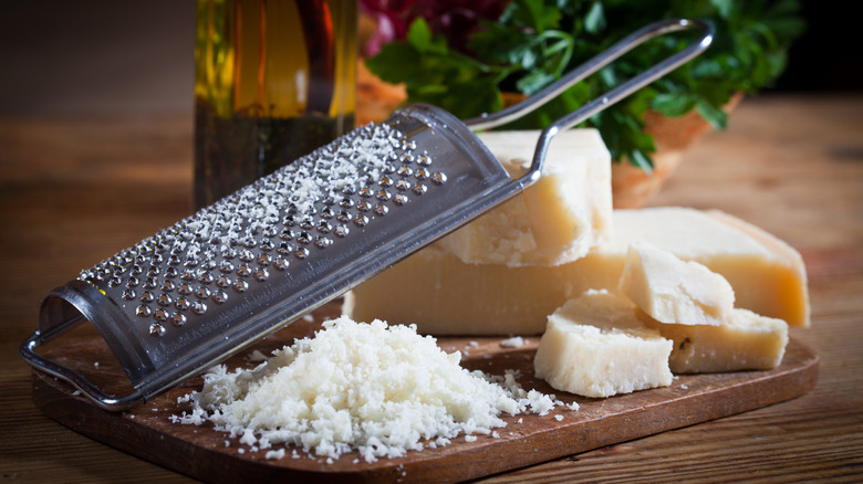 grated Parmesan cheese on board