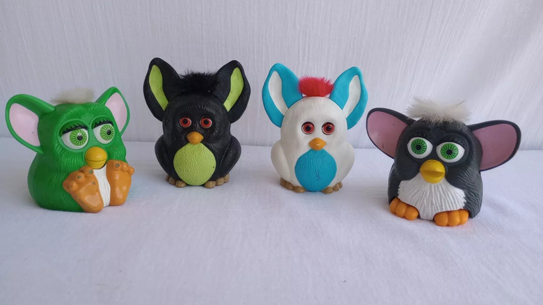 four plastic Furby toys