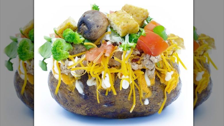 Baked potato with fresh veggies and shredded cheese