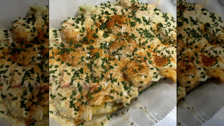 Loaded potato with shrimp, white sauce, and seasoning