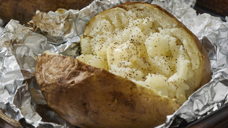 Baked Jacket potato in foil with butter and black pepper