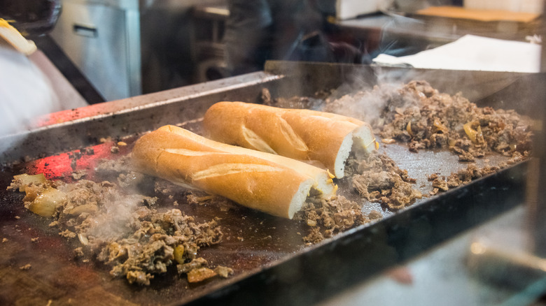 cheesesteaks being cooked