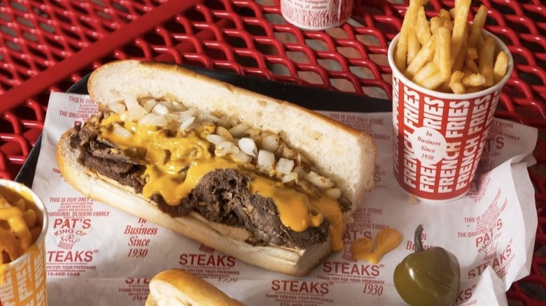 A cheesesteak and cup of fries