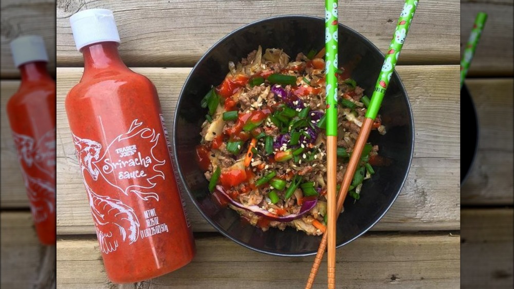 Trader Joe's sriracha sauce with egg roll bowl and chop sticks