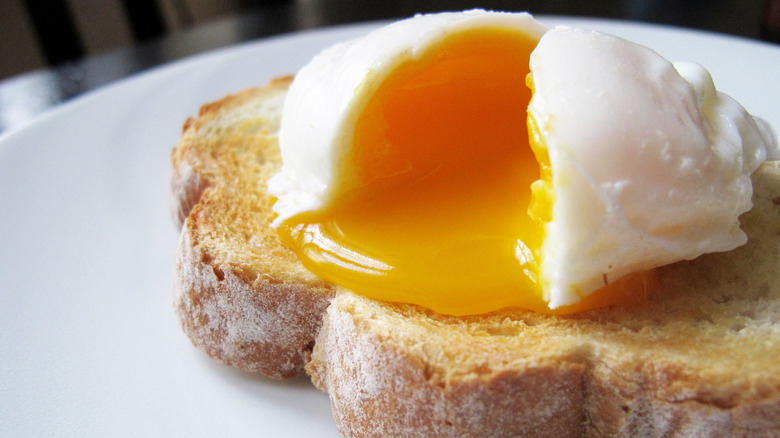 Poached egg with broken yolk