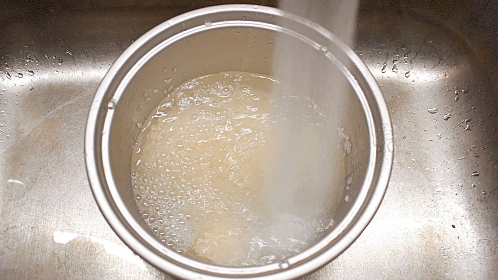 Rice being rinsed for 20-minute sesame chicken