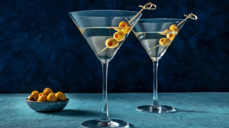 Two martinis against blue background