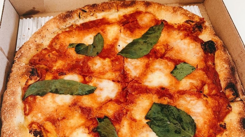 Margherita pizza in a to go pizza box