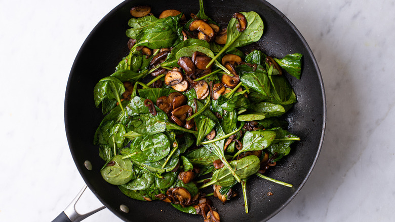 warm spinach salad in skillet