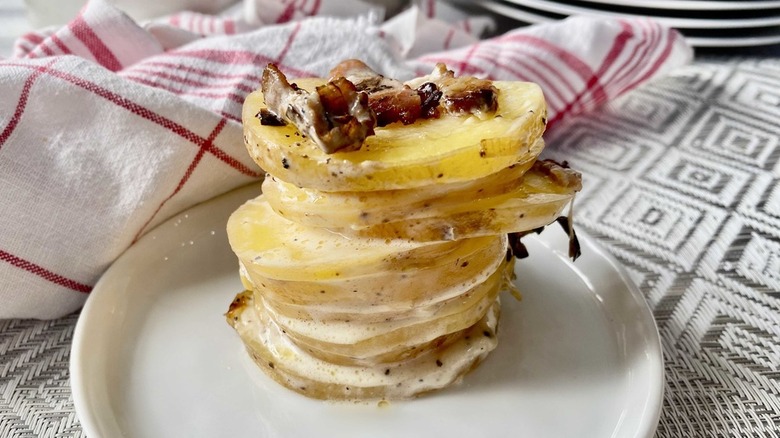 Scalloped potatoes on white plate