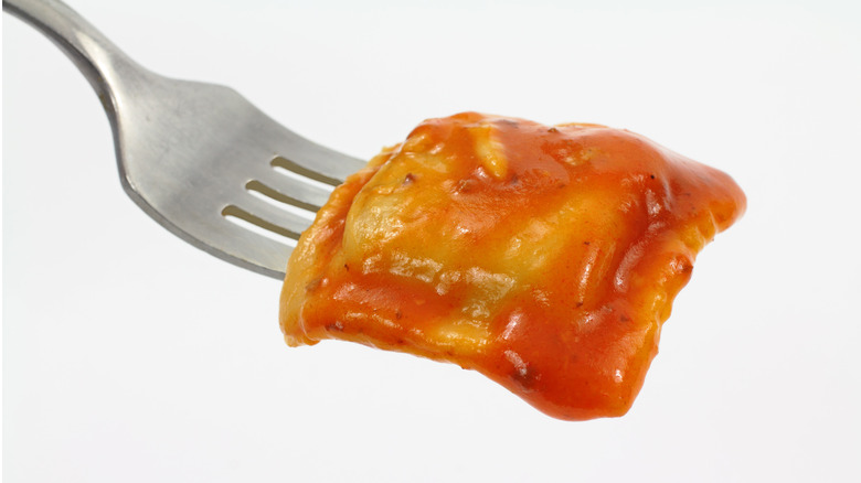 sauced can ravioli on fork