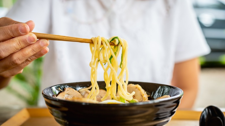 eating ramen with chopsticks