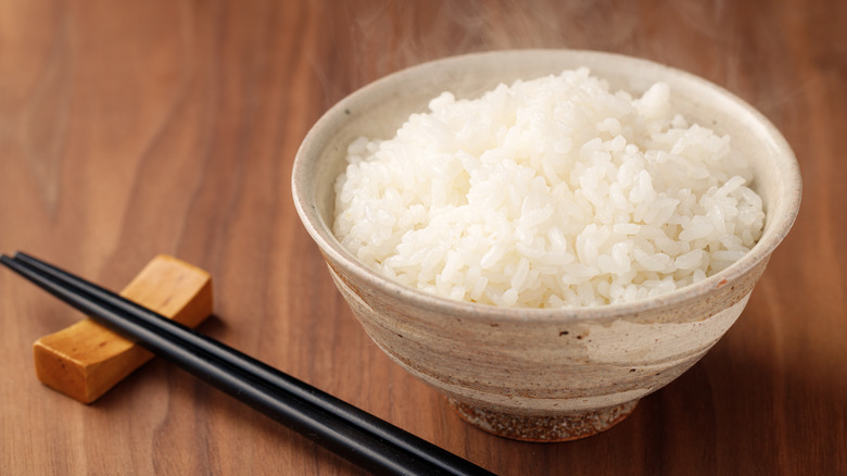 white rice bowl with chopsticks