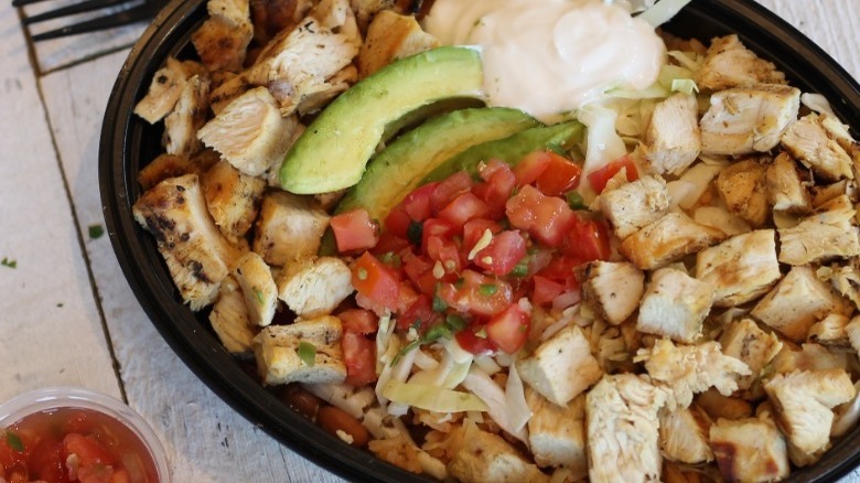 El Pollo Loco  Double Chicken Avocado Salad on wood table