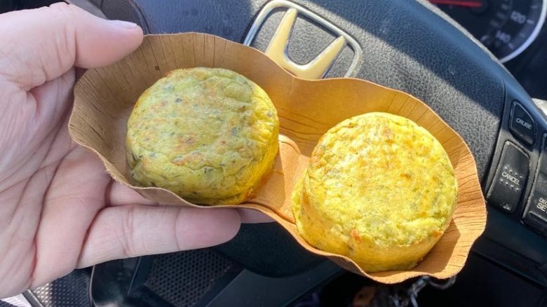 Someone holding Starbucks Kale and Mushroom Egg Bites in car
