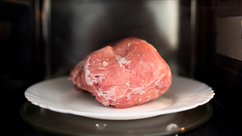 Pork roast defrosting in microwave