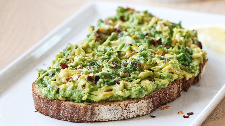 Avocado toast on white plate