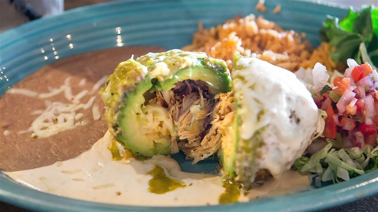 Stuffed Avocado dish with sides