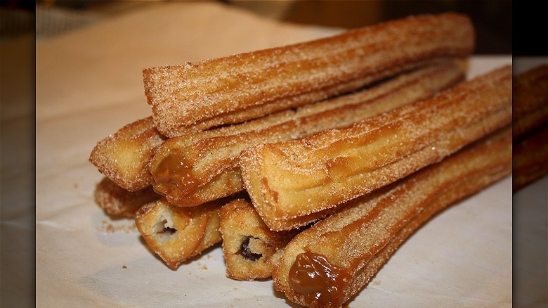 Churros stacked on plate