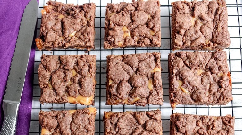 5-Ingredient Chocolate Caramel Cookie Bars on rack with knife