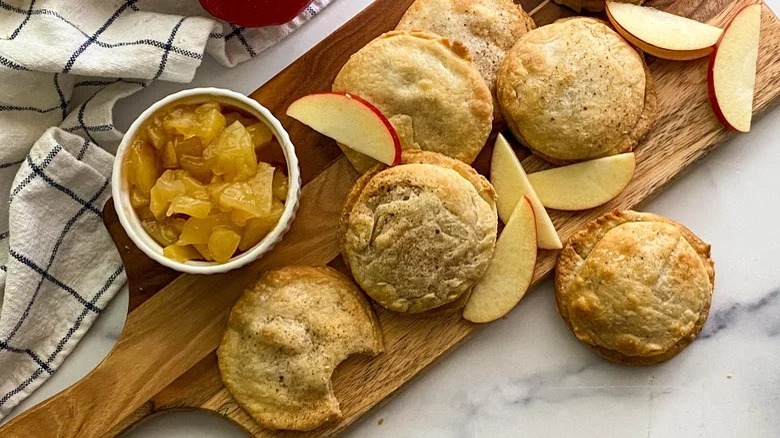 Apple Pie Cookies on cutting board with bowl of chopped apples