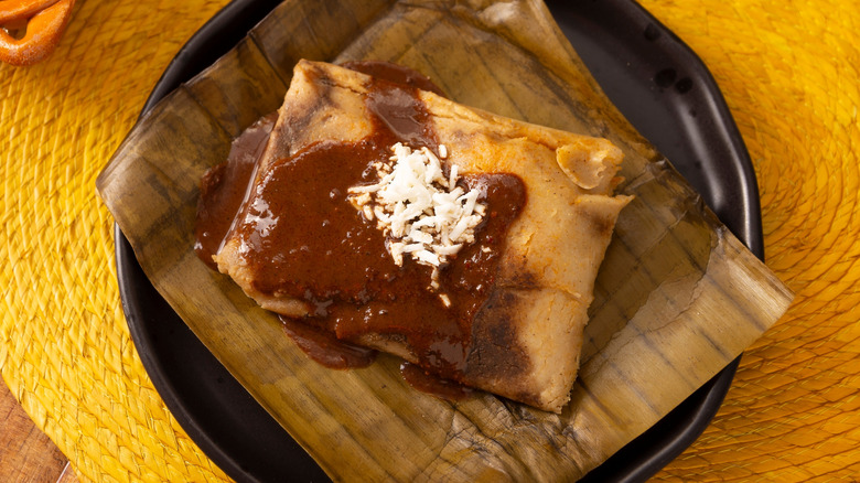 Tamales with sauce on plate