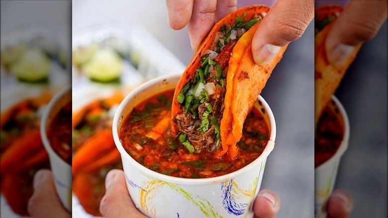 Birria-Landia consomme dipped taco