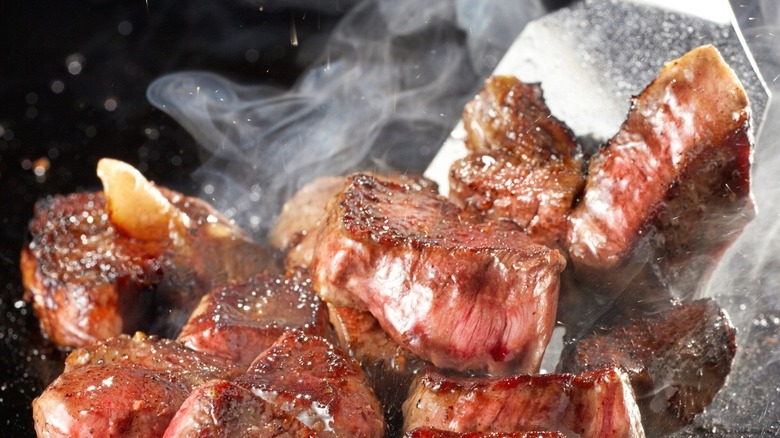 cubes of steak on a hibachi