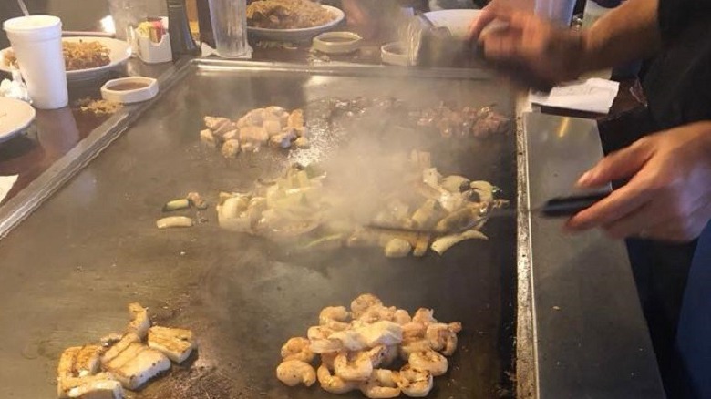 chef cooking on a hibachi