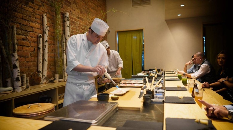 sushi chef with soufflé torch