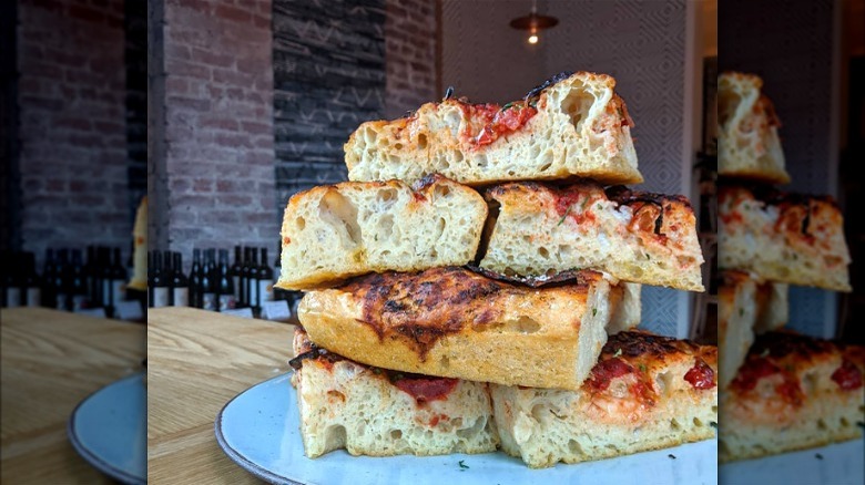 Stacked focaccia slices on plate