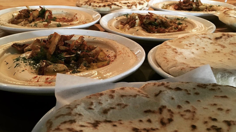 plates of pita and mushroom hummus