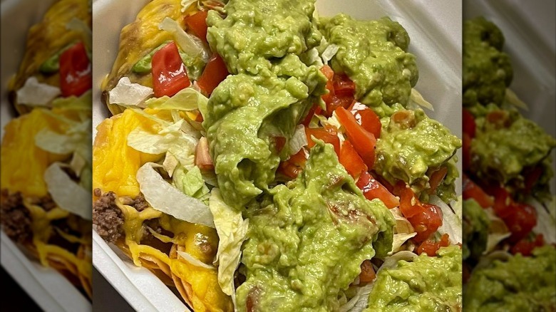 Nachos with guacamole and tomatoes 