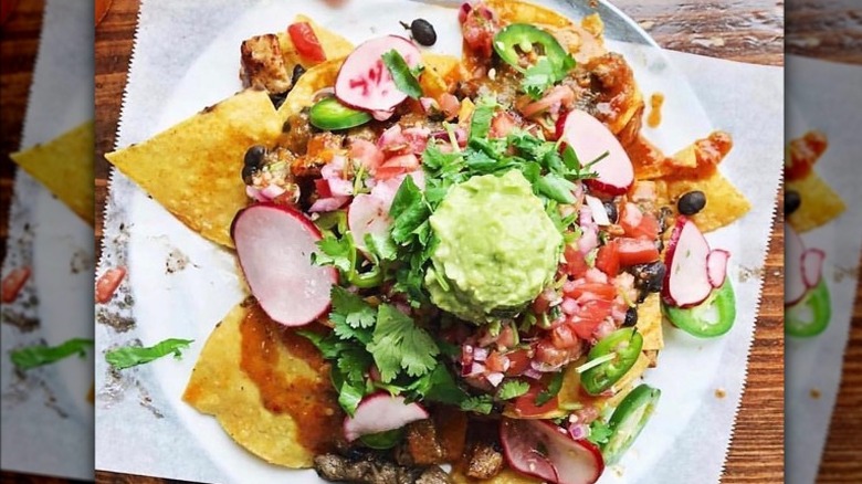 Nachos with guacamole and radishes 