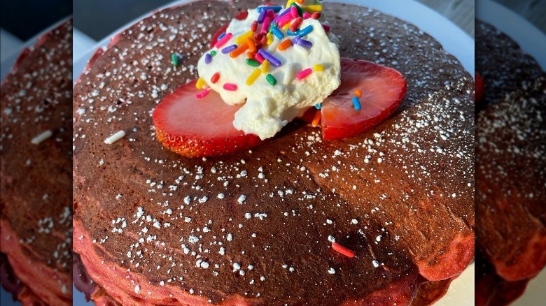 Red pancakes with cream 