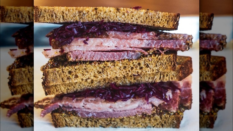 two pastrami sandwich halves stacked