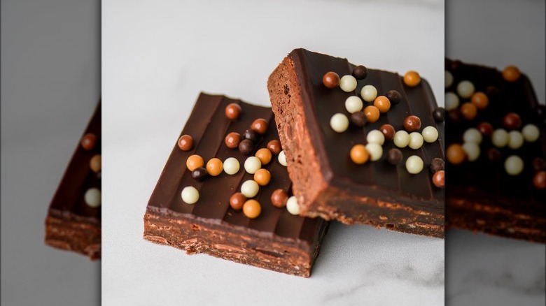 Two overlapping brownies with chocolate pearls
